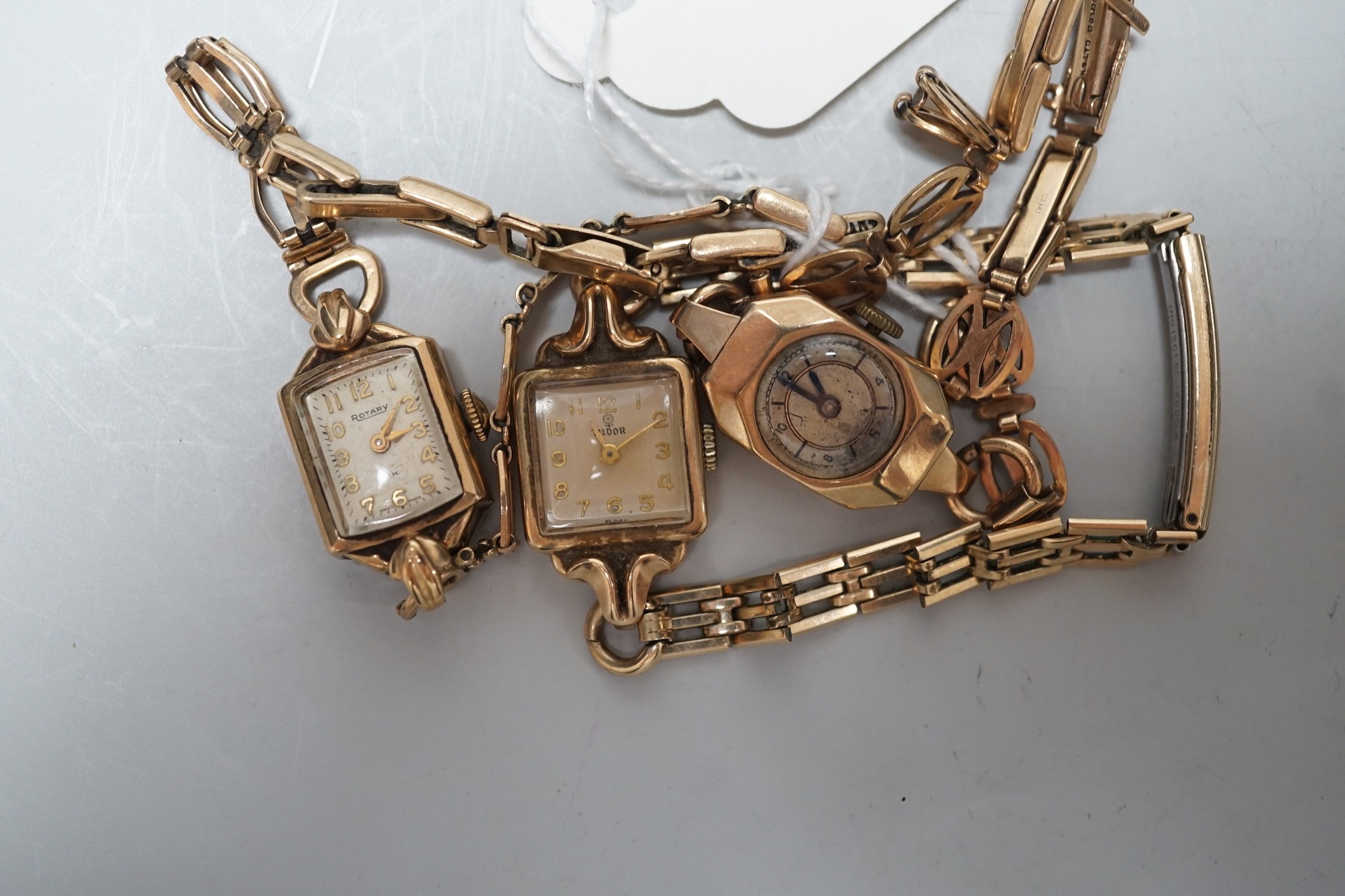 Two lady's 9ct gold manual wind wrist watches, including Rotary, on 9ct gold bracelets, gross weight 26.2 grams and a lady's 9ct gold Tudor manual wind wrist watch, on a steel and gold plated bracelet.